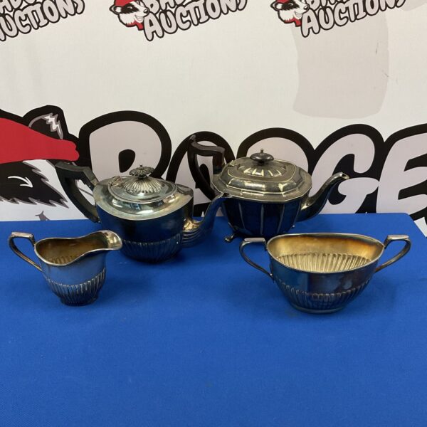 Vintage silver plate tea set with teapot, creamer, and bowl.