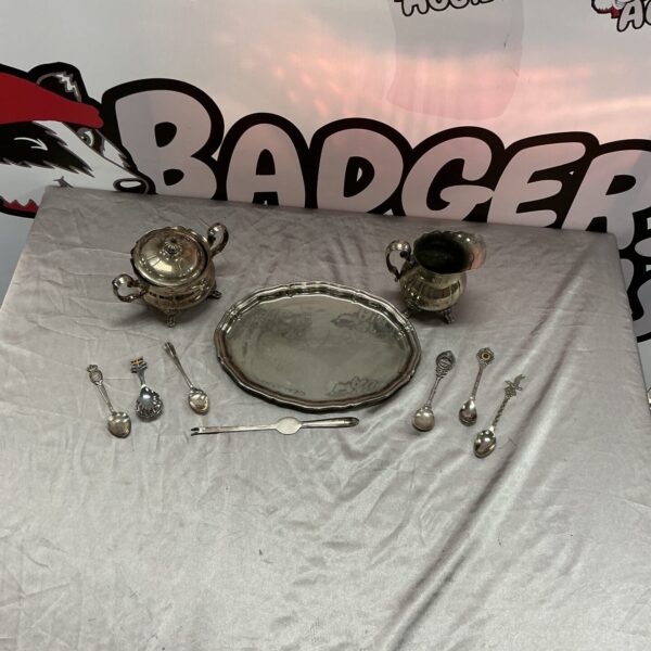 Vintage silver plate tea set with milk jug, sugar bowl, and tray.