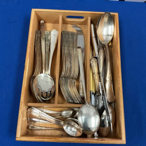 Vintage silverplate cutlery set displayed in a wooden box.