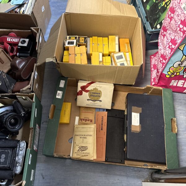 Vintage collection of photographic slides and negatives in boxes.