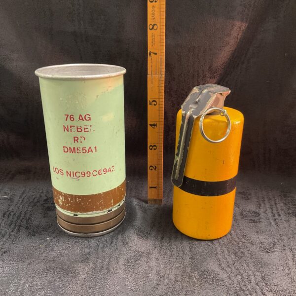 Yellow vintage smoke canister, military collectible item.