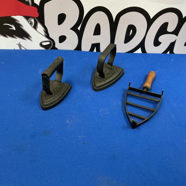 Pair of antique cast iron smoothing irons for vintage clothing.