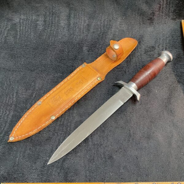 Vintage stack leather sheath knife with leather handle.