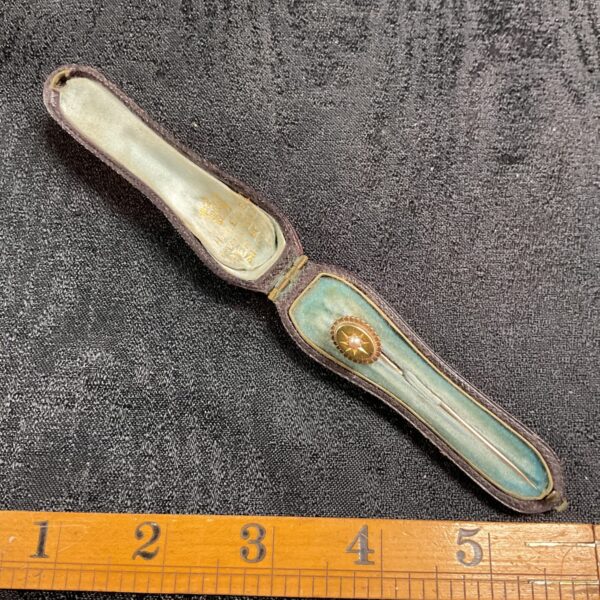 Vintage stick pin set in teal case, antique jewellery collectible.
