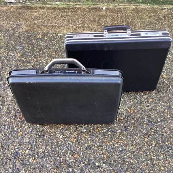 Black vintage Samsonite and Potterton suitcases, retro travel luggage.