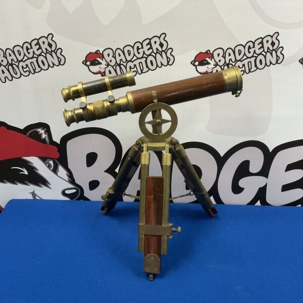 Vintage surveyor's scope with wooden body and brass details.