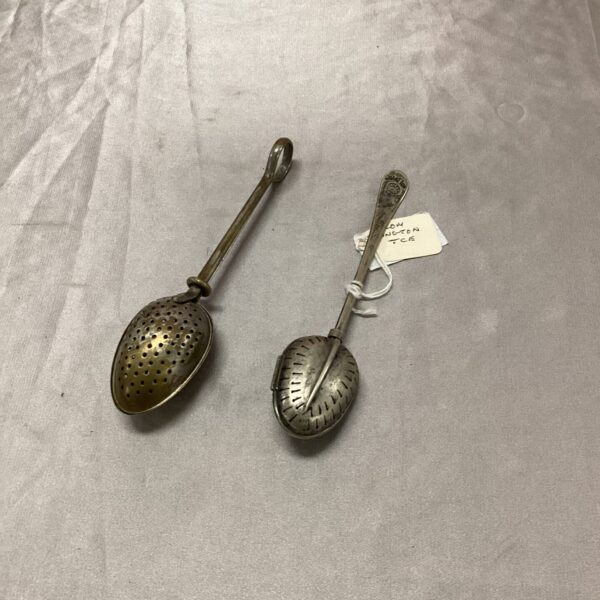 Vintage silver plated tea strainer with floral design.