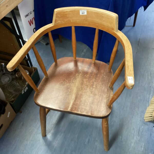 Vintage teak carver chair with sculpted seat and backrest.