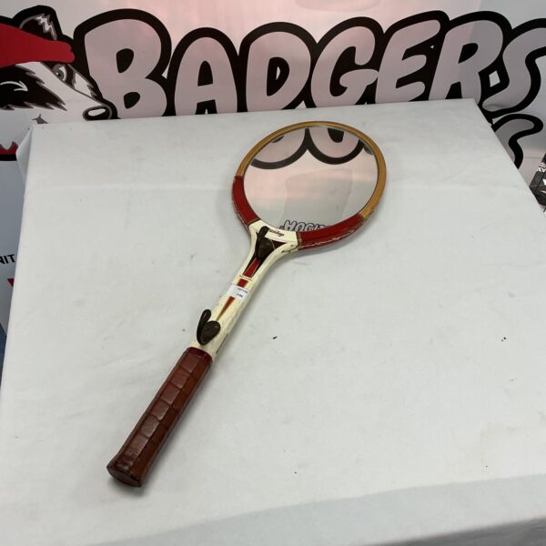 Vintage tennis racket displayed as unique wall decor.