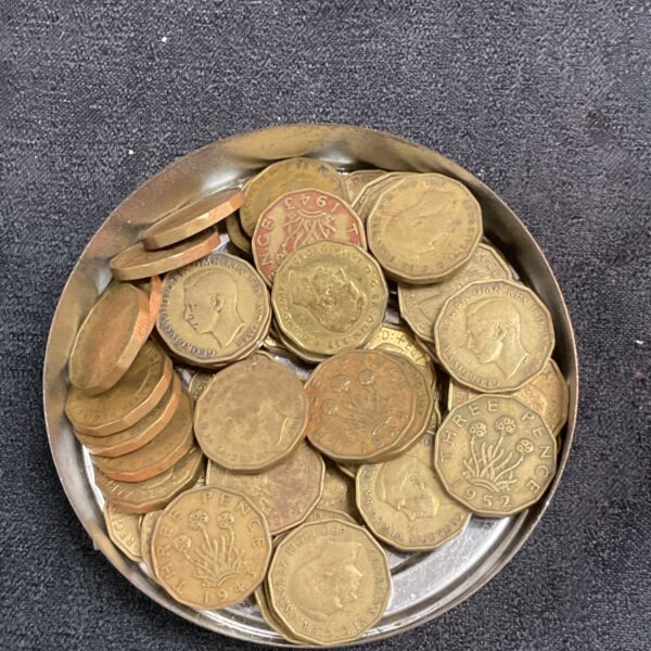 Vintage brass three penny coins in a lot for collectors.