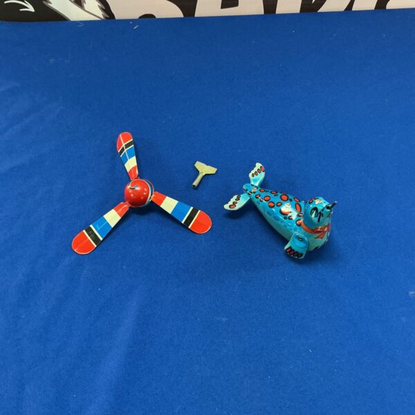 Vintage tin plate clockwork seal toy, colourful and detailed.