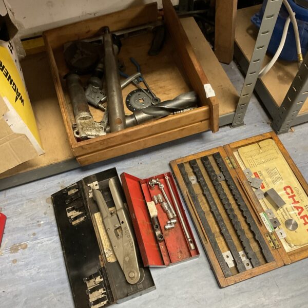 Vintage tool set in wooden case with metalworking implements.