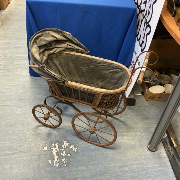 Vintage wicker toy pram, antique doll carriage for collectors.