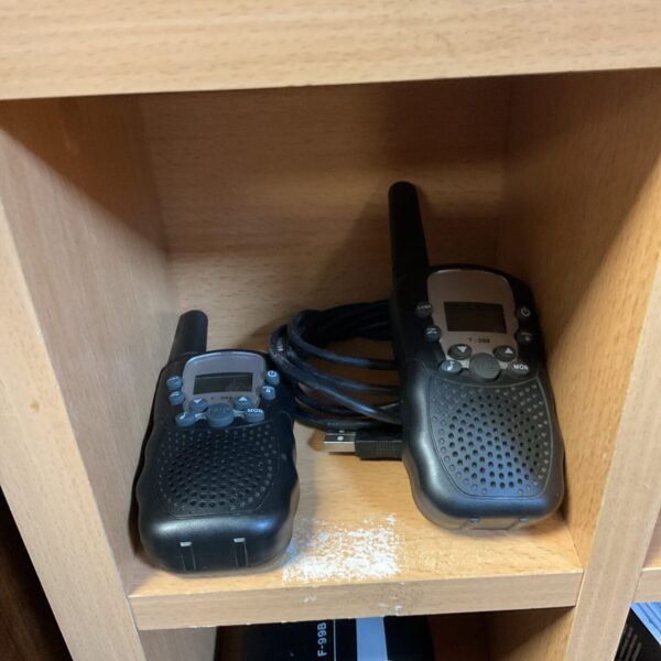 Black vintage walkie talkies, a pair of handheld communication devices.