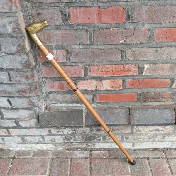 Vintage walking stick with detailed brass horse head handle.