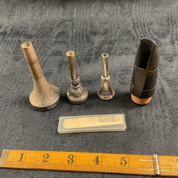 Vintage collection of wind instrument mouthpieces for saxophone and trumpet.