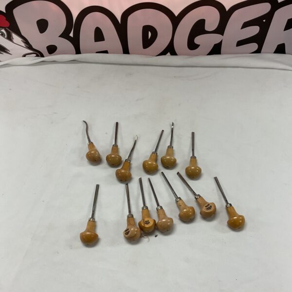 Vintage wood carving tools with wooden handles and steel blades.