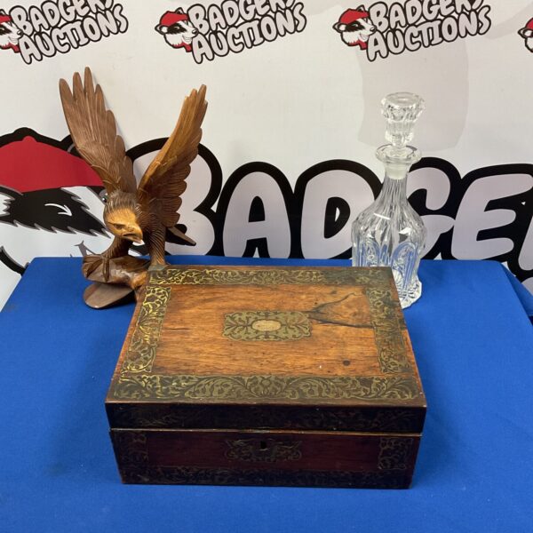 Vintage wooden box with carved eagle and brass inlay detail.