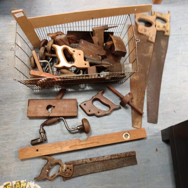 Vintage lot of woodworking tools including planes and saws.