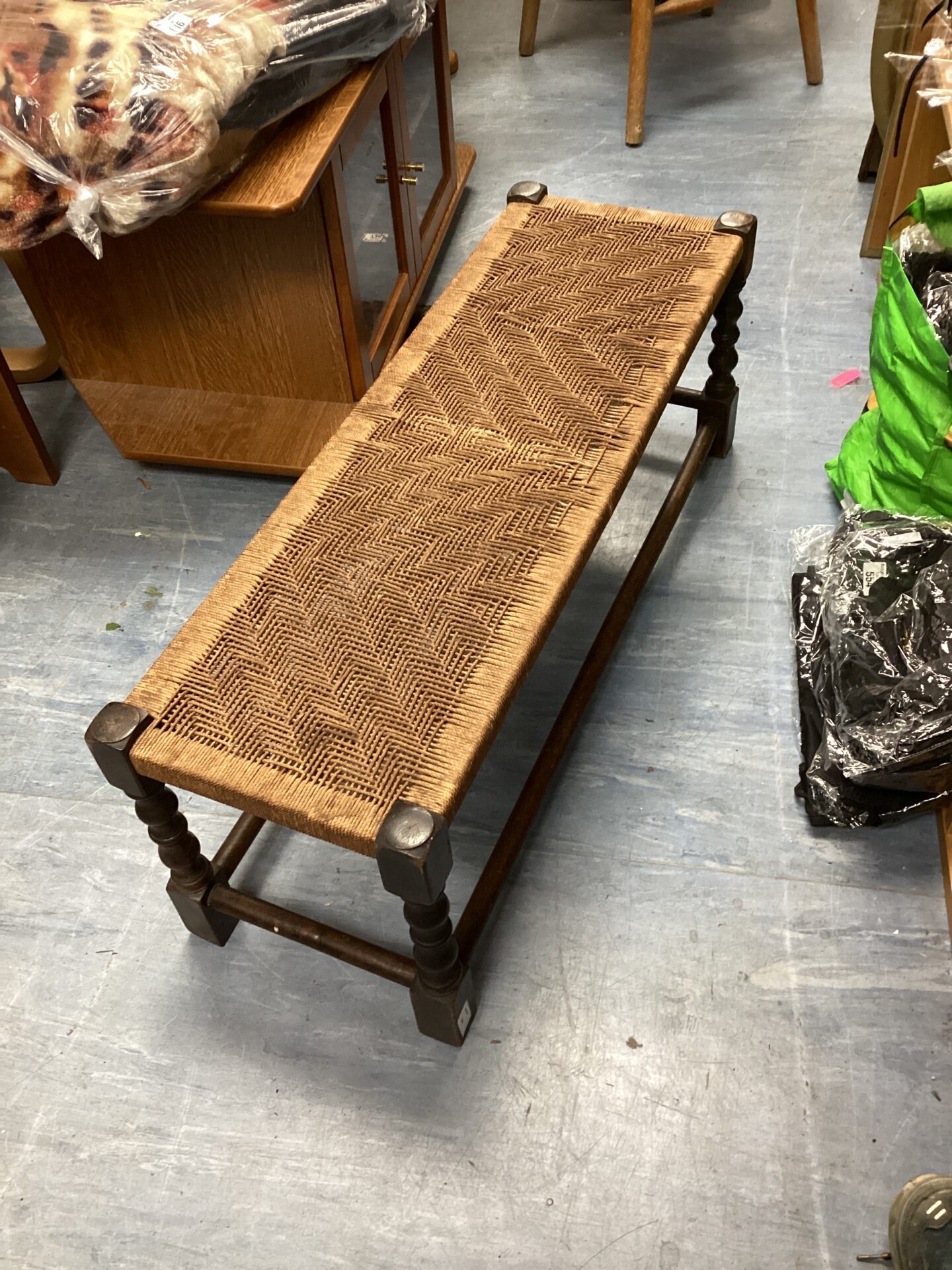 Vintage woven footstool with oak frame and rush seat.