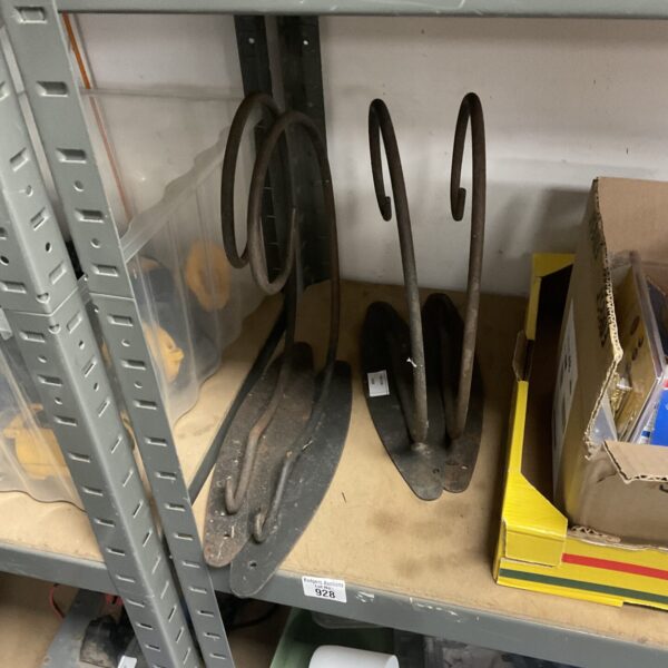 Set of four vintage wrought iron basket brackets for garden display.