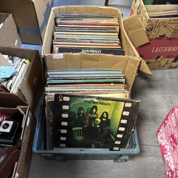Two boxes filled with a diverse vinyl record collection.