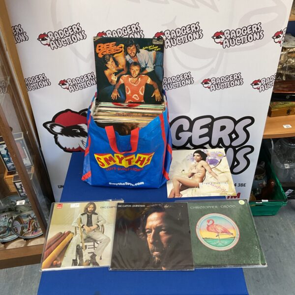 Vinyl record lot featuring Prince, Eric Clapton, and Bee Gees albums.