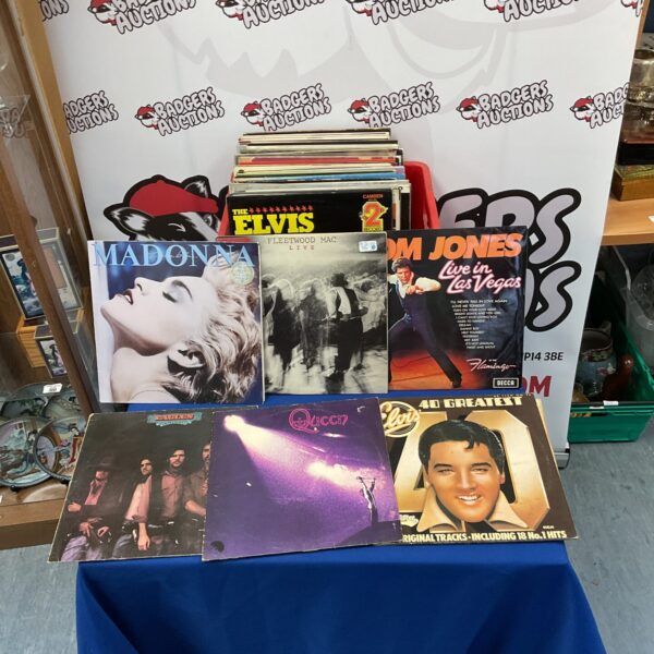 Vinyl record lot featuring Queen, Elvis, and Fleetwood Mac albums.