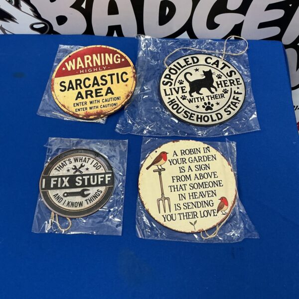 Set of four comical wall plaques for humorous home decor.