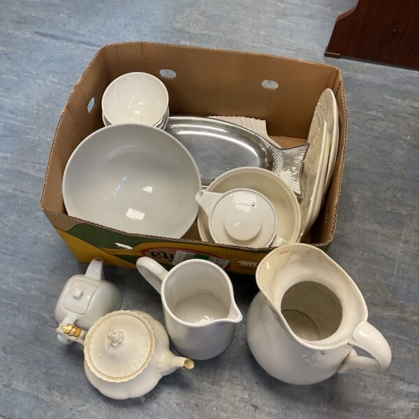 Overview of a mixed lot of white china serving dishes and teapots.
