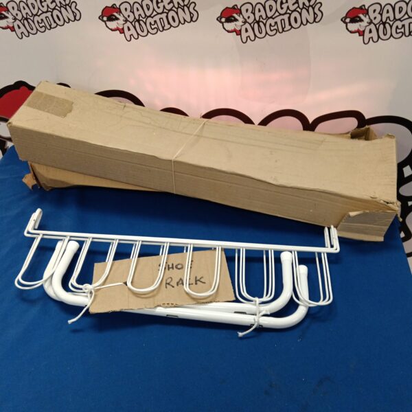 White metal tiered shoe rack for hallway storage.