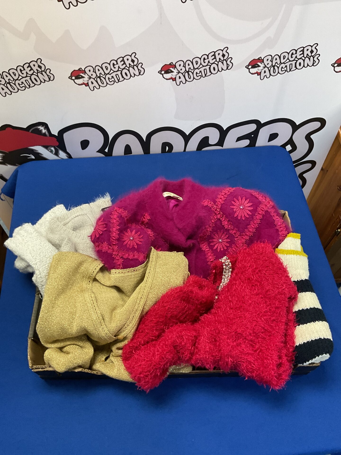 Women's clothing lot featuring soft knitwear and striped socks.