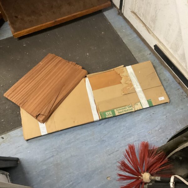 Stack of wood veneer strips for furniture restoration projects.