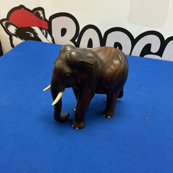 Detailed hand-carved wooden elephant figurine for home decor.