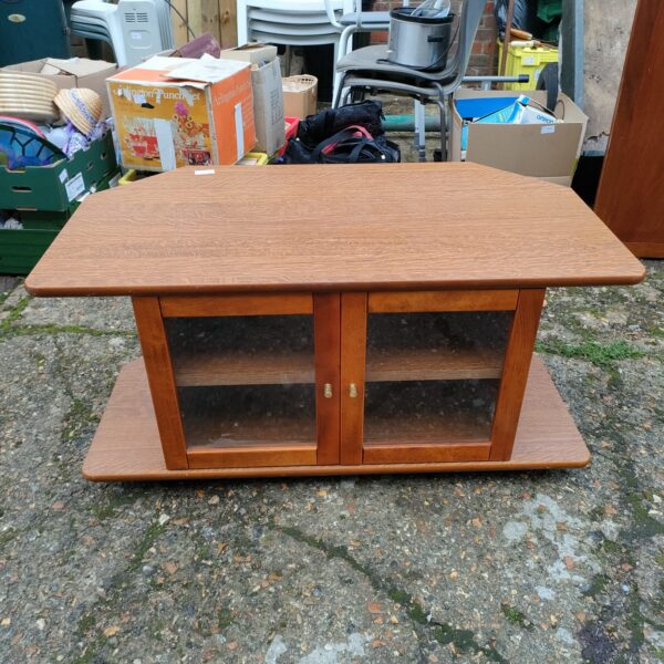 Vintage wooden glass fronted media cabinet for home entertainment.