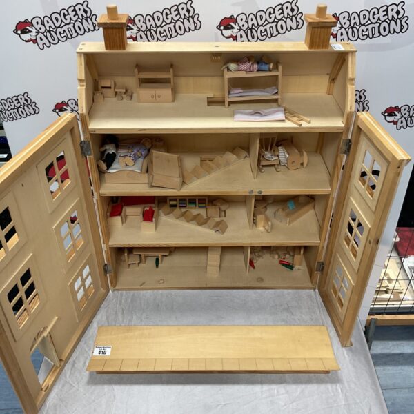 Front view of a vintage wooden toy house for kids.
