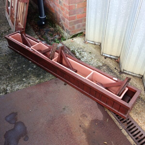 Large wooden window trough planter for garden display.