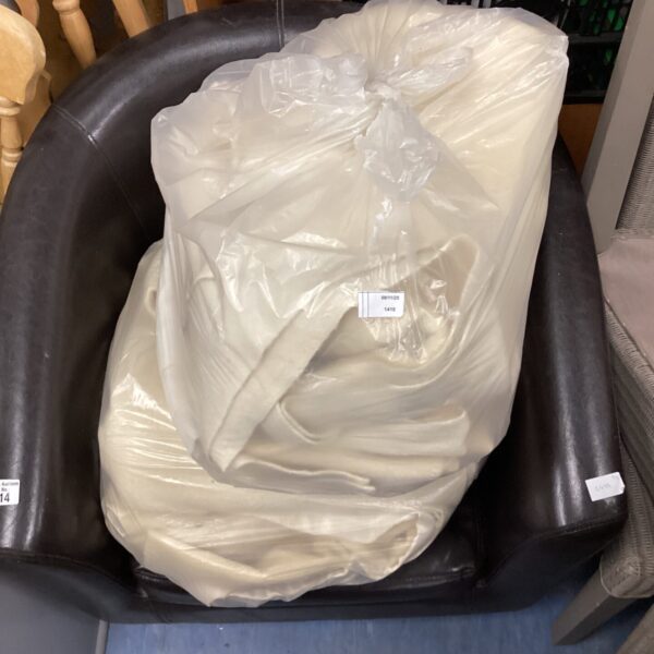 Two bags of bundled woolen blankets, vintage textiles.