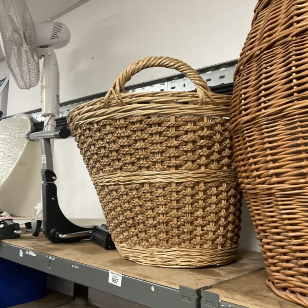 Large natural fibre woven laundry basket with handles.