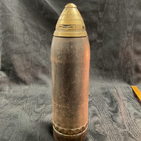 Full view of a WWI inert shell with brass fuse.