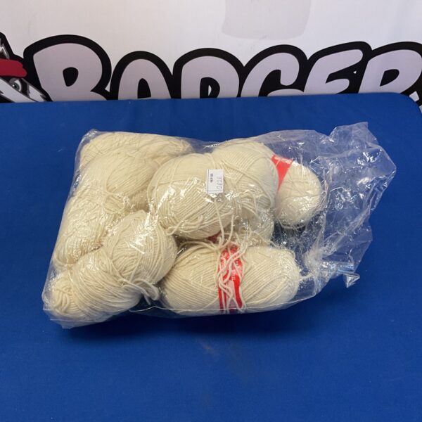 Creamy white yarn lot for knitting and crochet projects.