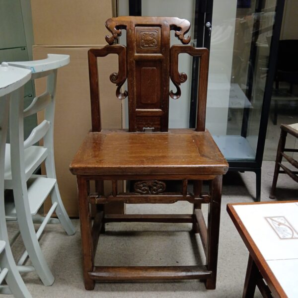 Antique 19th-century Chinese oak chair with carved details.