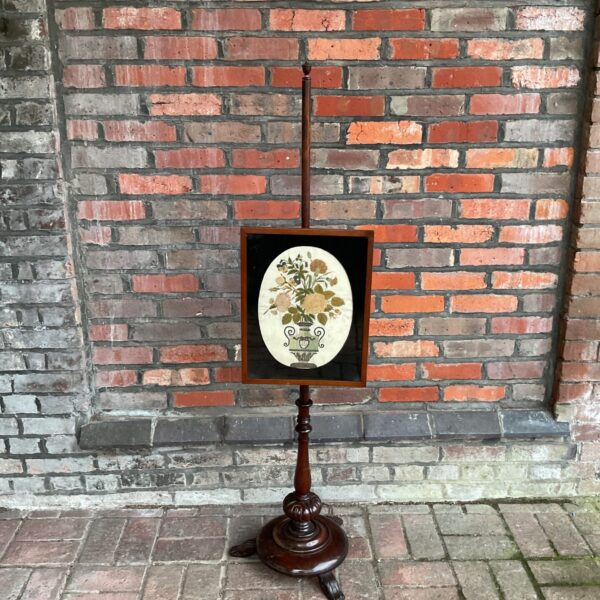 Antique 19th-century mahogany pole screen with floral tapestry.