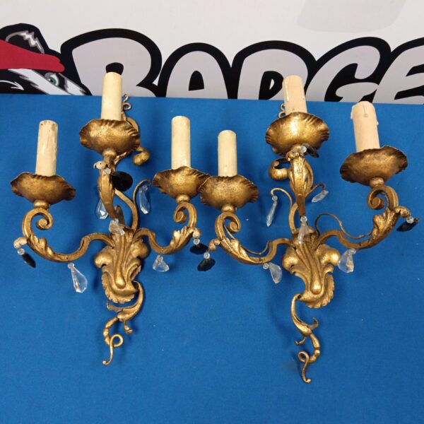 Ornate 19th-century wall sconces with amethyst stone drops for antique lighting.