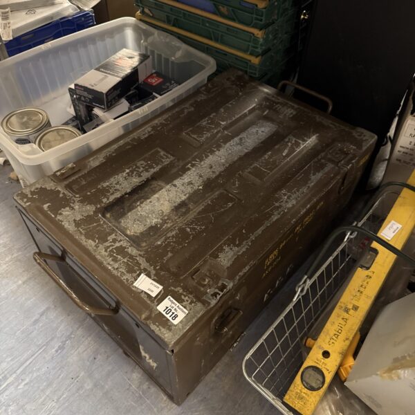 Front view of a vintage 84mm ammunition crate with wear.