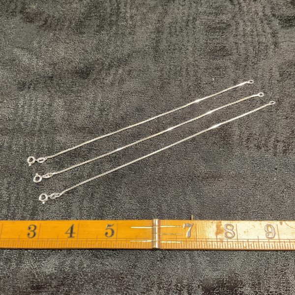 Trio of delicate 925 silver bracelets with chain links.