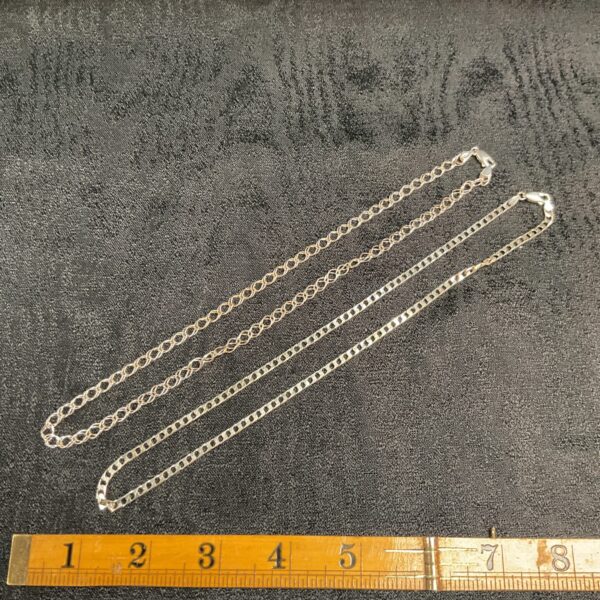 Pair of 925 silver chain necklaces on a neutral background.