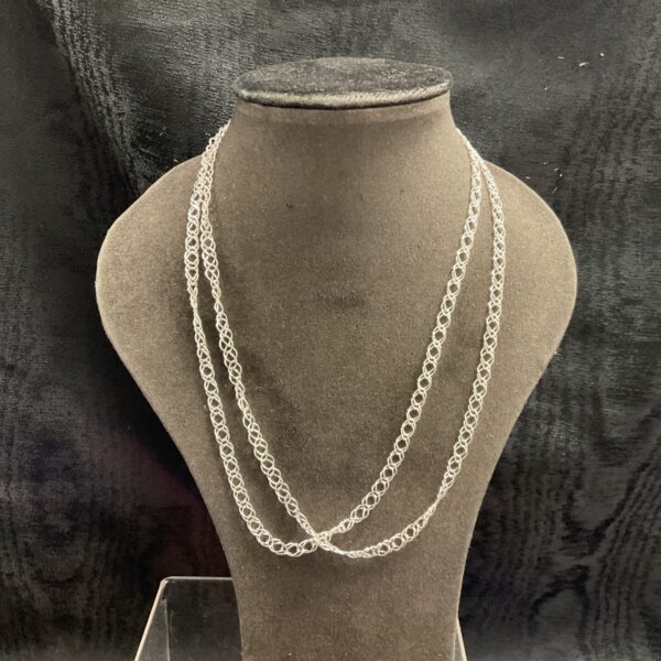 Pair of 925 silver chain necklaces on display.