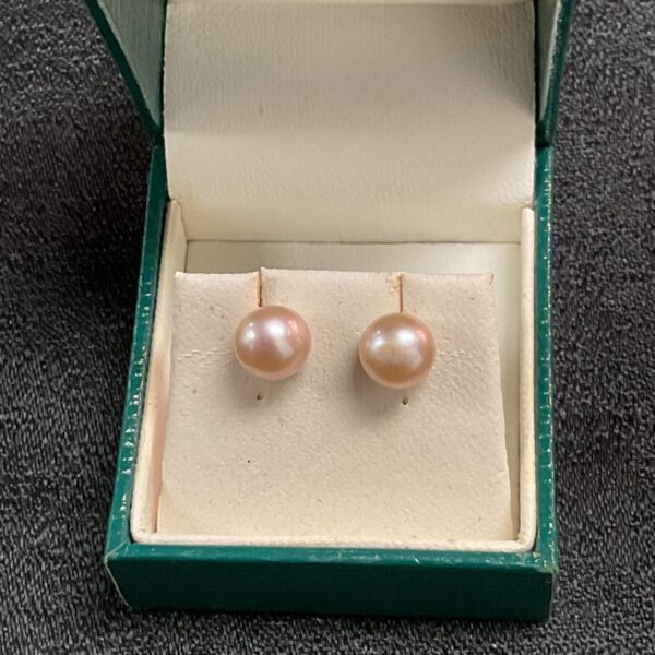 Classic 9ct gold and pearl stud earrings on display.