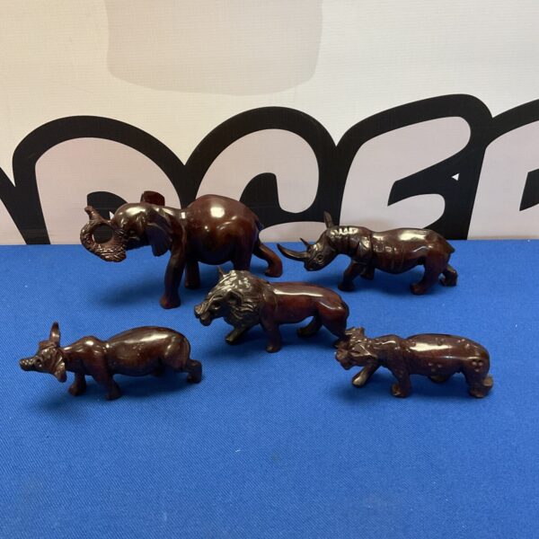 Set of five African Big Five wooden carvings on a white background.